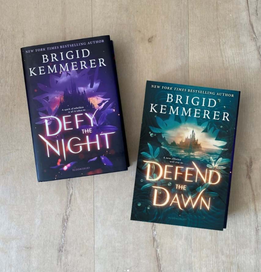 Defy the Night and Defend the Dawn Books on a Table. Author Brigid Kimmerer